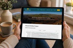 Jacksons Farm Holidays website displayed on a tablet showing Peak District holiday cottage availability and direct online booking from a home environment.